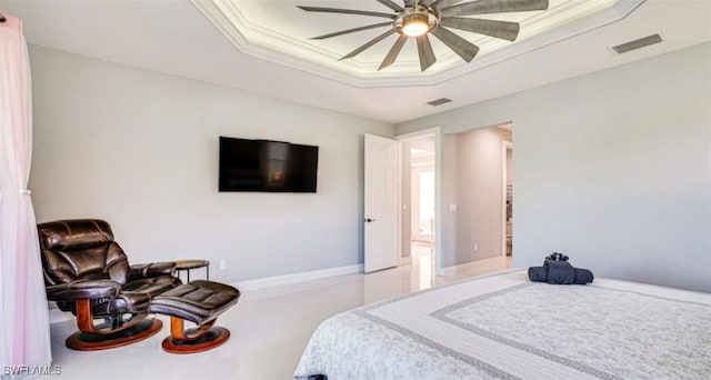 bedroom featuring ornamental molding, a tray ceiling, visible vents, and baseboards