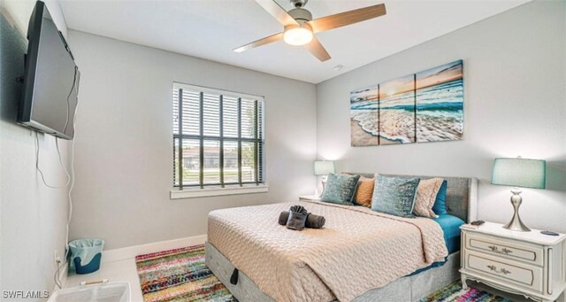 bedroom featuring a ceiling fan and baseboards