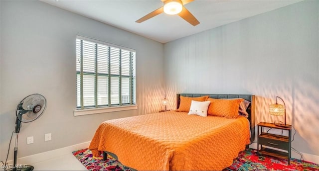 bedroom with ceiling fan and baseboards