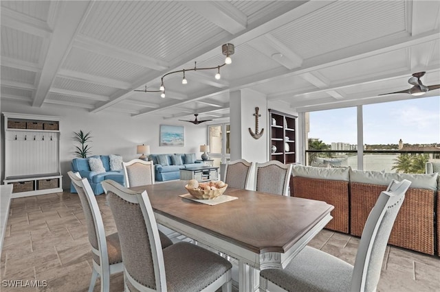 dining room featuring a ceiling fan, beam ceiling, coffered ceiling, and stone finish flooring