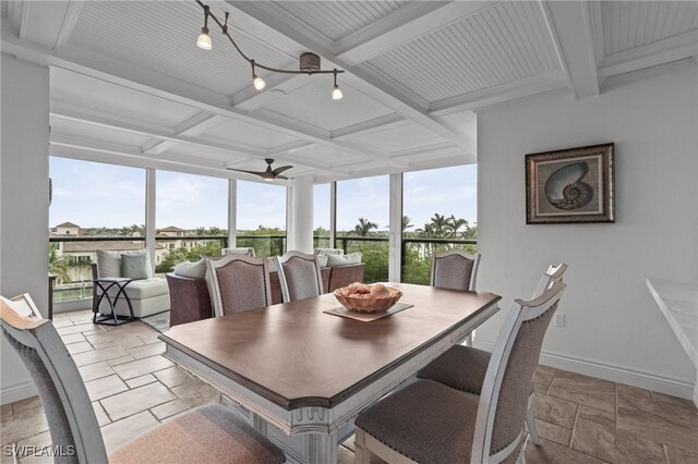 dining room with stone tile floors, baseboards, coffered ceiling, a ceiling fan, and beam ceiling