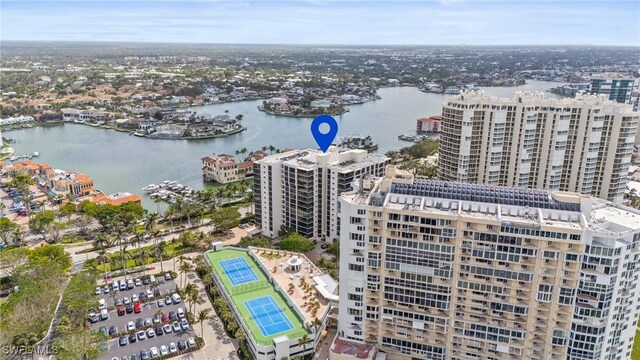 birds eye view of property featuring a view of city and a water view