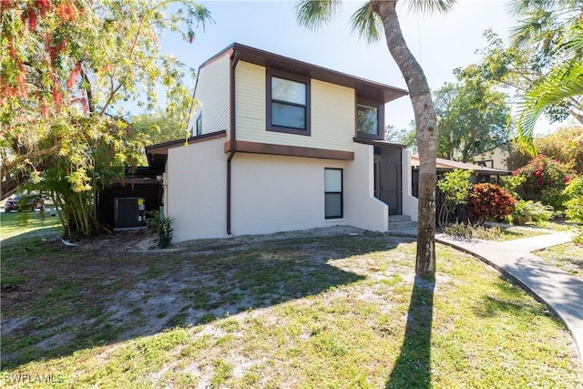 exterior space with a lawn and stucco siding