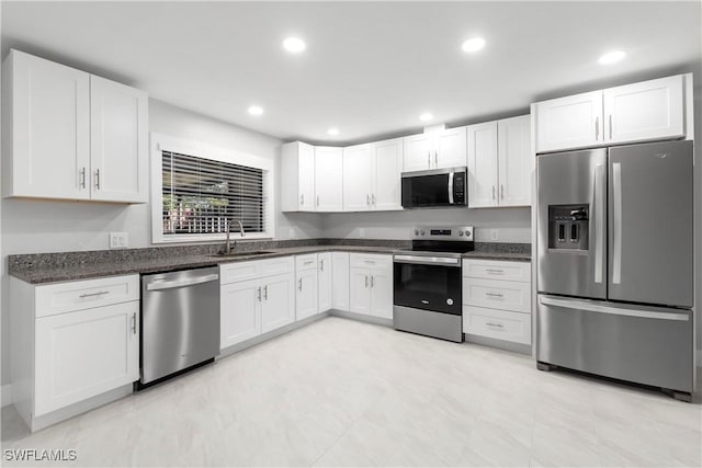 kitchen with white cabinets, recessed lighting, appliances with stainless steel finishes, and a sink