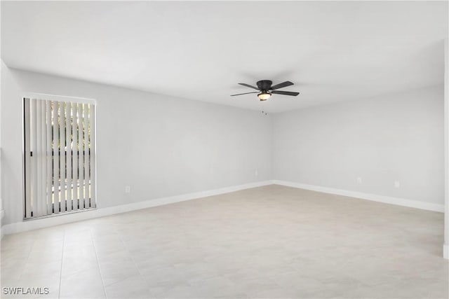 empty room featuring baseboards and a ceiling fan