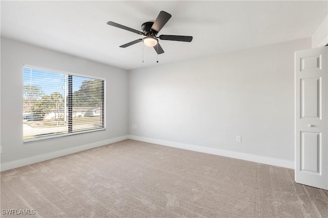 spare room with baseboards, carpet floors, and ceiling fan