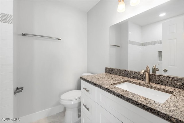 full bath featuring vanity, toilet, and baseboards