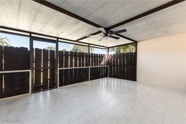 unfurnished sunroom with a ceiling fan