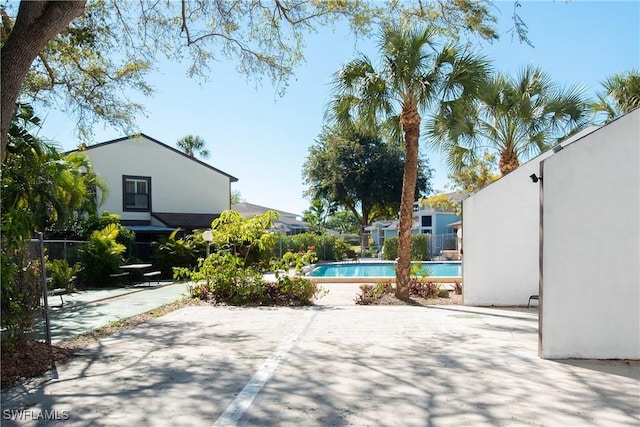 view of pool featuring a fenced in pool, fence, and a patio area