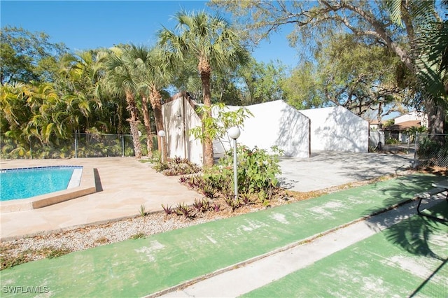 view of pool with a patio area, fence, and a fenced in pool