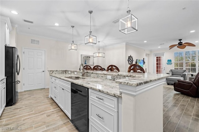 kitchen featuring black appliances, a sink, white cabinetry, crown molding, and wood tiled floor