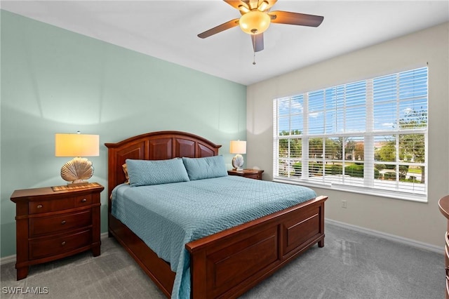 carpeted bedroom featuring ceiling fan and baseboards