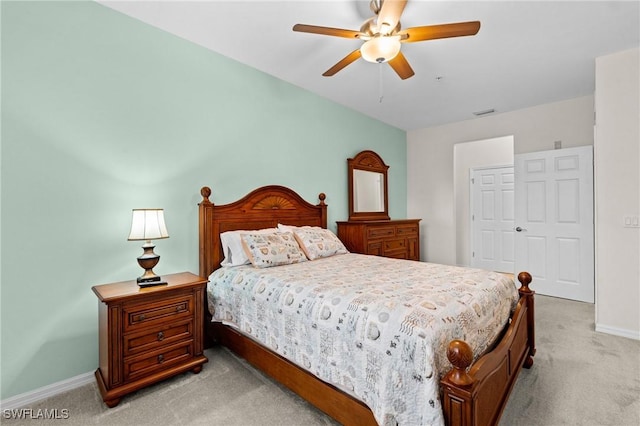 bedroom featuring ceiling fan, visible vents, baseboards, and light carpet