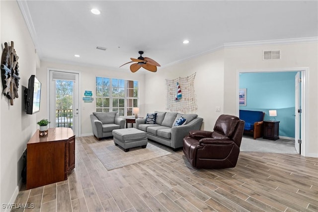 living room featuring visible vents, crown molding, baseboards, recessed lighting, and light wood-style flooring