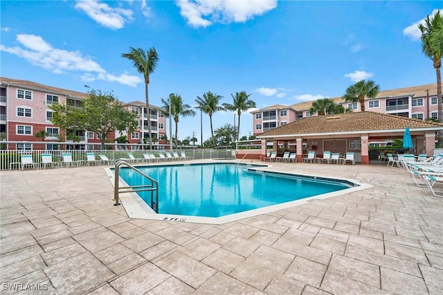 community pool featuring a patio and fence