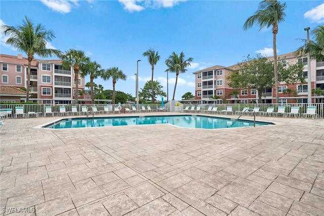 pool featuring a patio and fence