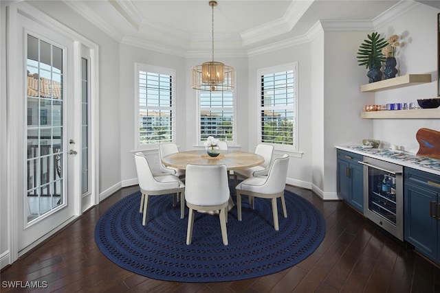 dining area with wine cooler, dark wood-type flooring, a raised ceiling, and crown molding