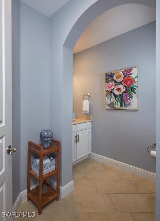 bathroom with tile patterned flooring, vanity, and baseboards