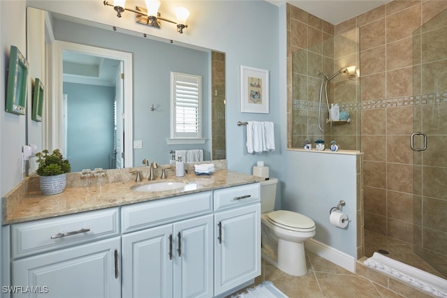 bathroom featuring tile patterned floors, toilet, a stall shower, crown molding, and vanity