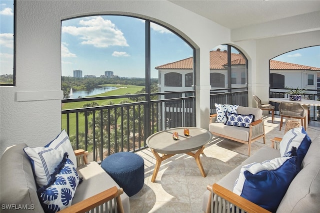 sunroom featuring a water view