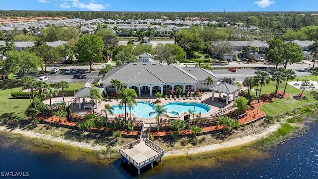 drone / aerial view with a residential view and a water view