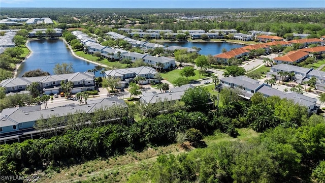 drone / aerial view featuring a water view and a residential view