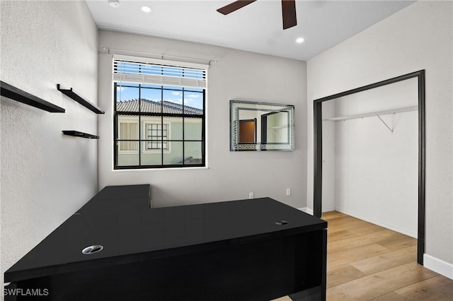 unfurnished bedroom with baseboards, recessed lighting, wood finished floors, a closet, and a ceiling fan