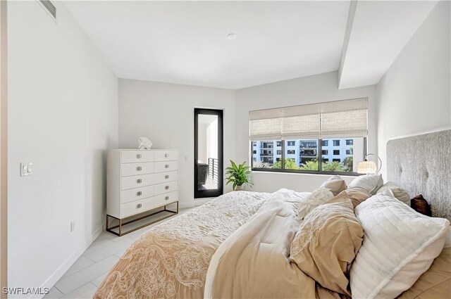 bedroom featuring access to outside, visible vents, and baseboards