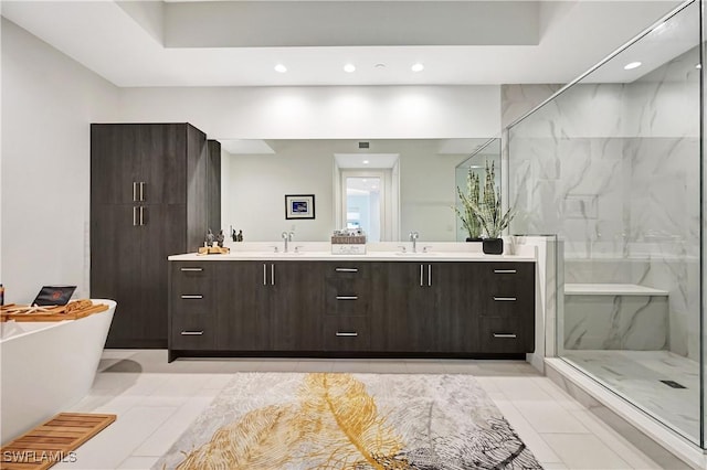 full bathroom with double vanity, a soaking tub, a marble finish shower, and a sink