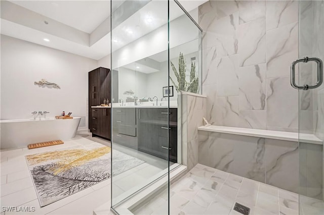 full bath featuring a stall shower, recessed lighting, a freestanding bath, and vanity