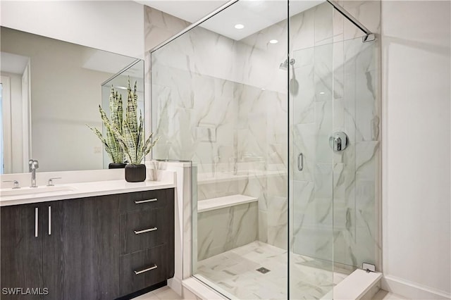 full bathroom featuring a marble finish shower, vanity, and recessed lighting