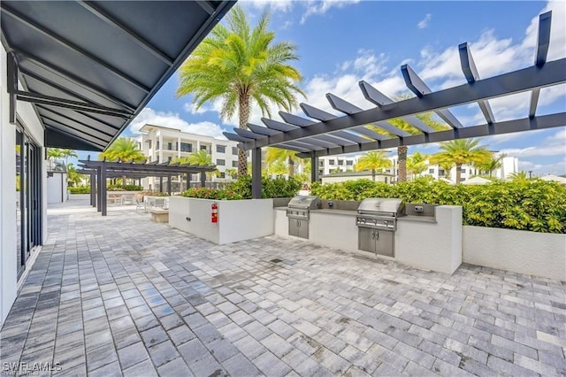 view of patio with a pergola, grilling area, and exterior kitchen