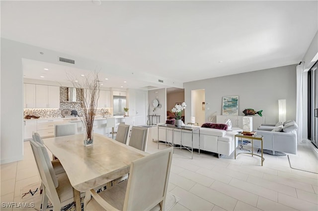 dining room with light tile patterned flooring, visible vents, and recessed lighting