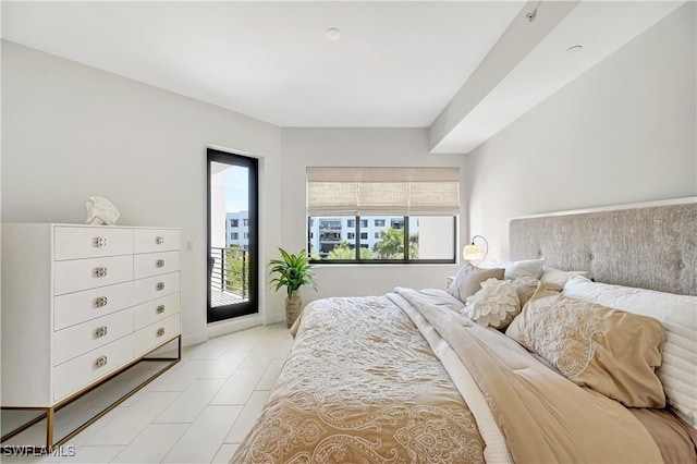 bedroom featuring light tile patterned flooring and access to exterior