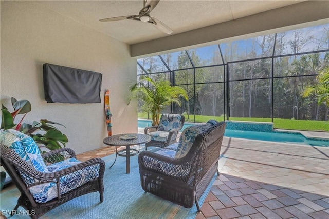 view of patio / terrace featuring glass enclosure, ceiling fan, an outdoor hangout area, and an outdoor pool