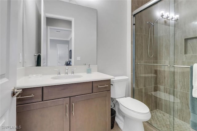 full bath with toilet, a stall shower, and vanity