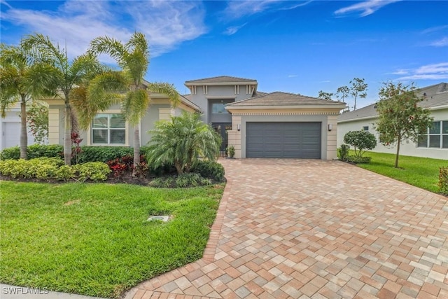 view of front of house featuring a garage, a front lawn, decorative driveway, and stucco siding