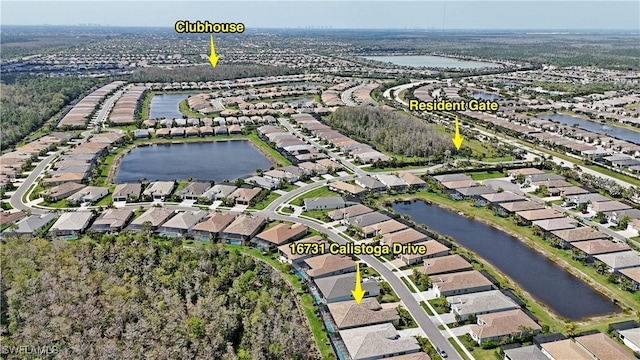 birds eye view of property with a water view and a residential view