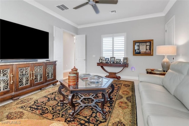 living room with ornamental molding, visible vents, and a ceiling fan