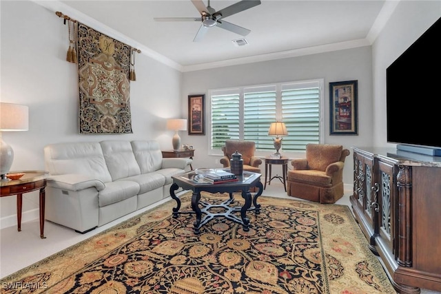 carpeted living area featuring ornamental molding, visible vents, ceiling fan, and baseboards