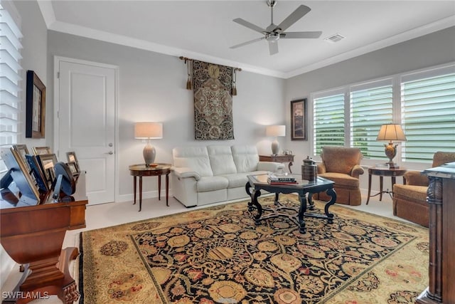 living room featuring ceiling fan, visible vents, ornamental molding, and baseboards