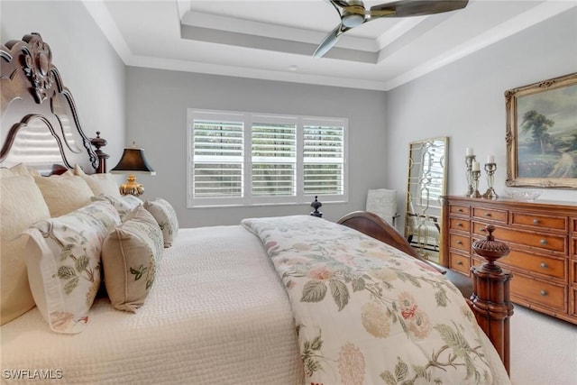 bedroom featuring ceiling fan, a tray ceiling, and crown molding