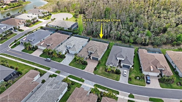 bird's eye view featuring a water view and a residential view