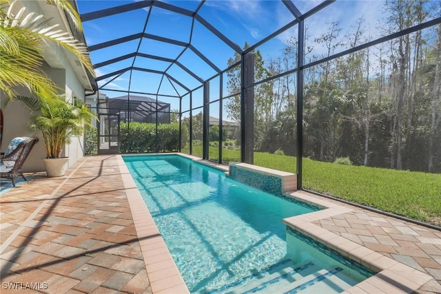 outdoor pool featuring a lanai, a patio, and a lawn