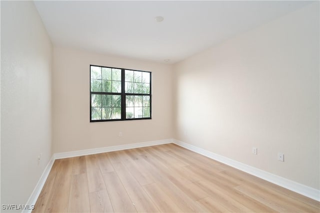 empty room featuring light wood-style flooring and baseboards