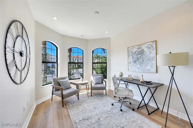 home office with recessed lighting, light wood-type flooring, and baseboards