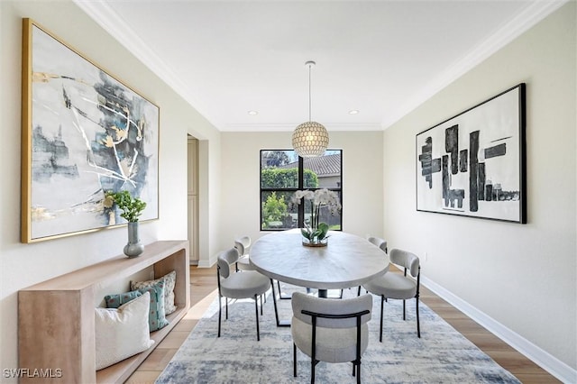 dining area with baseboards, recessed lighting, wood finished floors, and crown molding