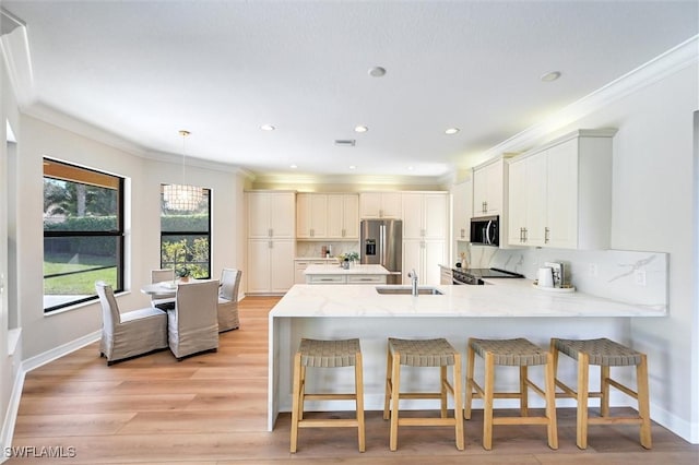 kitchen featuring tasteful backsplash, appliances with stainless steel finishes, light wood-style floors, ornamental molding, and a peninsula