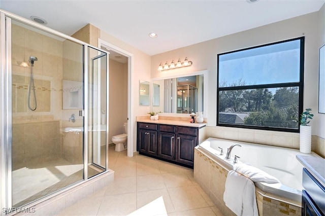 full bathroom featuring toilet, a shower stall, tile patterned flooring, and vanity