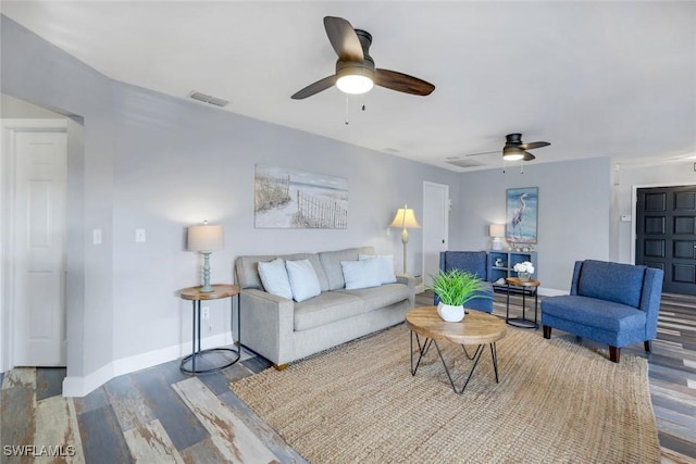 1416 SW 52nd Ter, Cape Coral, FL 33914 - living room featuring a ceiling fan, wood finished floors, and baseboards
